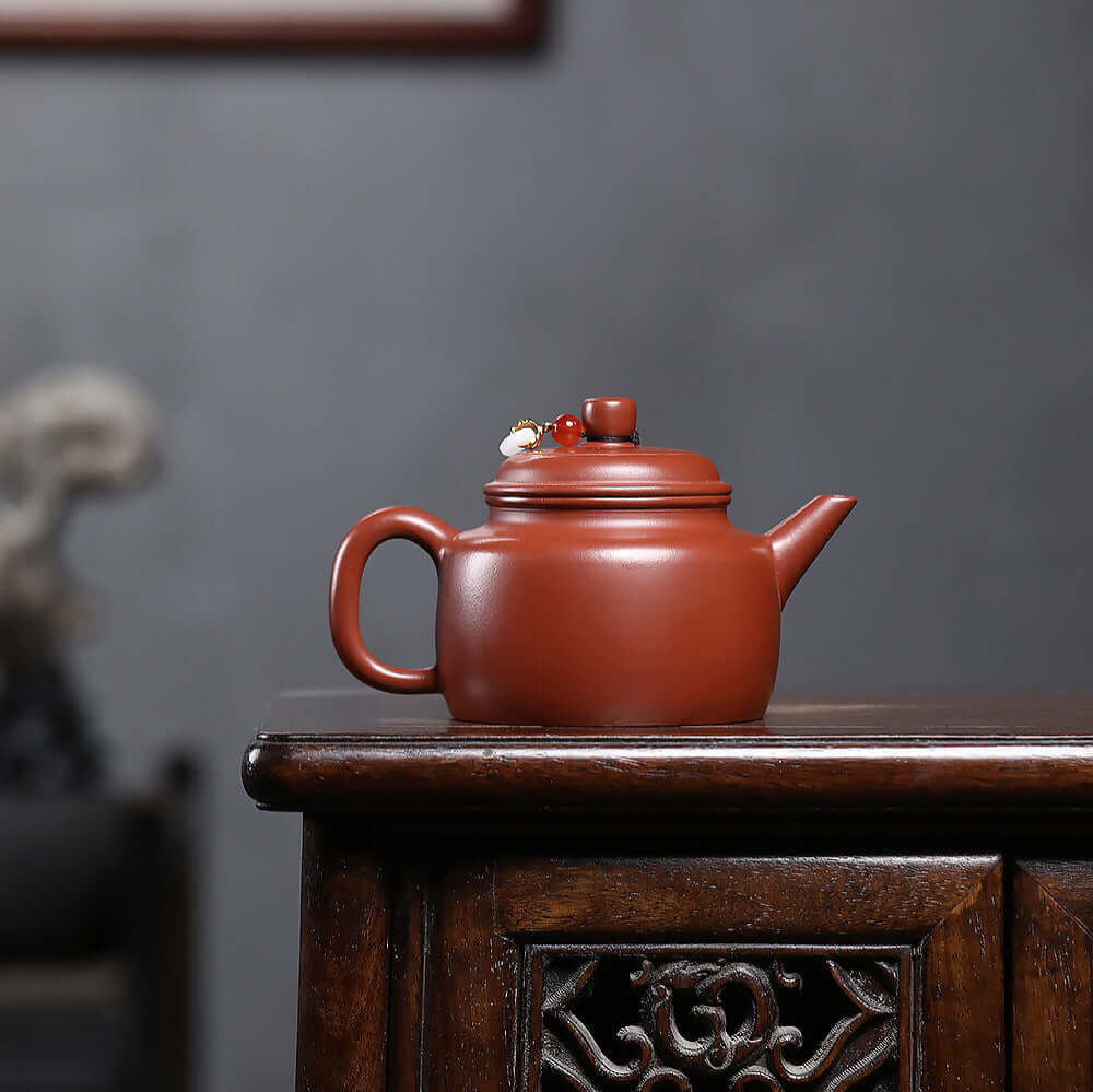 Handmade Yixing purple sand teapot with a traditional design, showcasing craftsmanship in a kung fu tea set.