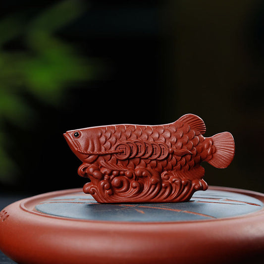 Handmade Yixing purple sand tea pet sculpture of a golden dragon fish, perfect for tea ceremonies.