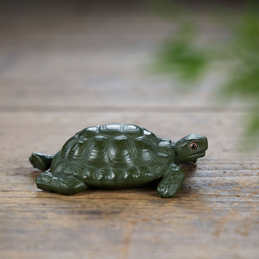 Handmade green mud turtle sculpture, Yixing purple sand tea pet ornament for creative tea table decor.