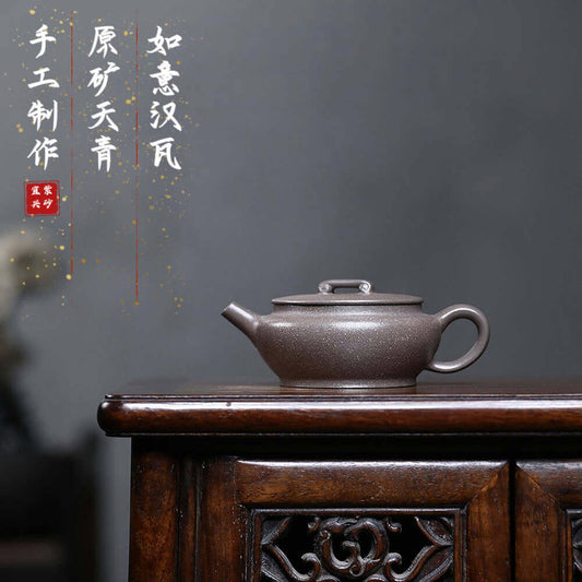 Handmade Yixing purple sand teapot on wooden table, original purple clay craftsmanship for tea lovers.