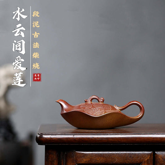 Handmade Yixing purple sand teapot featuring intricate lotus design, crafted using ancient methods and firewood burning.