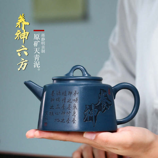 Handmade Yixing purple sand teapot in sky green clay, featuring elegant design and artisan inscription, perfect for tea lovers.