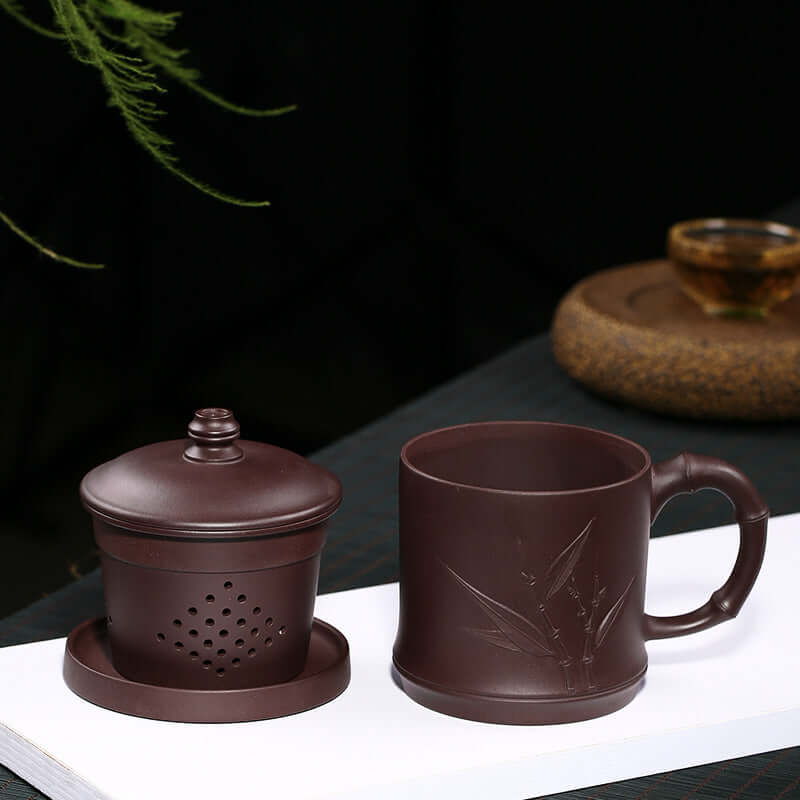 Handmade Yixing purple sand cup and tea pot set, crafted with bamboo leaf design, perfect for tea enthusiasts.