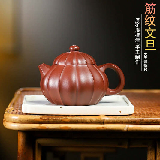 Handmade Yixing purple sand teapot featuring a unique ribbed design, ideal for home tea ceremonies.
