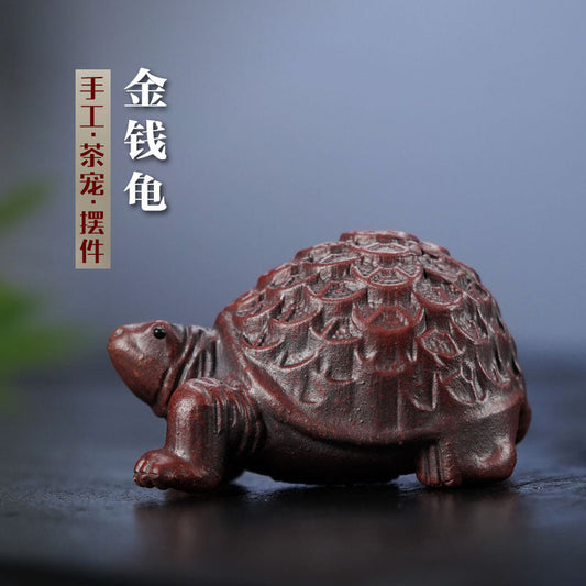 Handmade Yixing purple sand tortoise ornament, ideal for tea pet decoration in home or office.