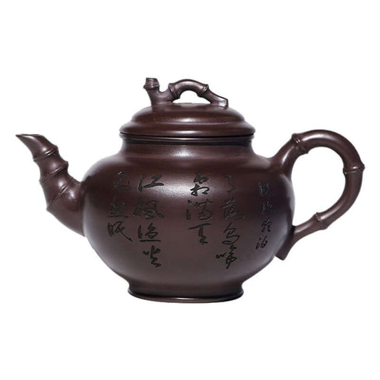 Handmade Yixing purple sand teapot with bamboo design and inscriptions, showcasing traditional craftsmanship.