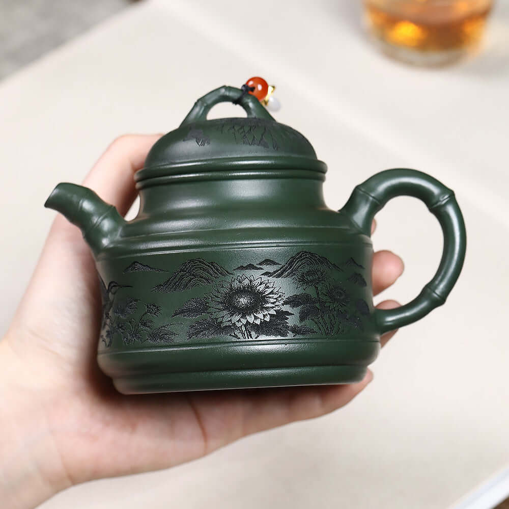 Handmade Yixing purple sand teapot, mineral green clay, engraved flowers and birds, bamboo tripod design.