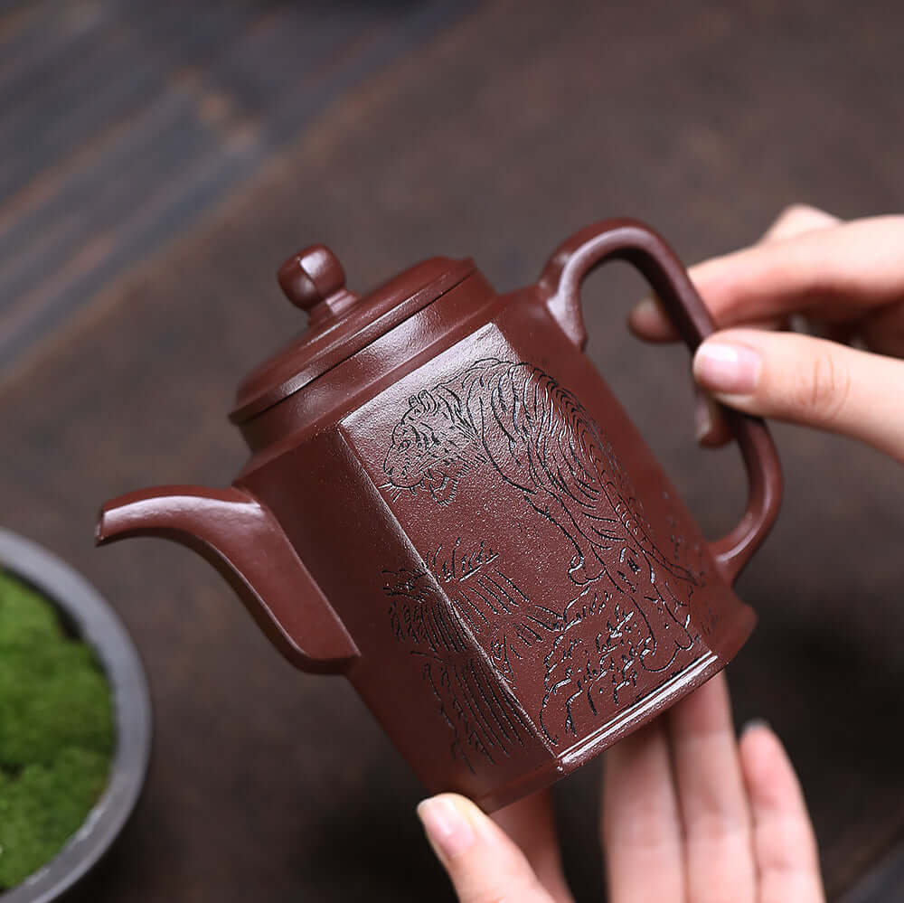 Handmade Yixing purple sand teapot with intricate design, perfect for home kung fu tea sets.