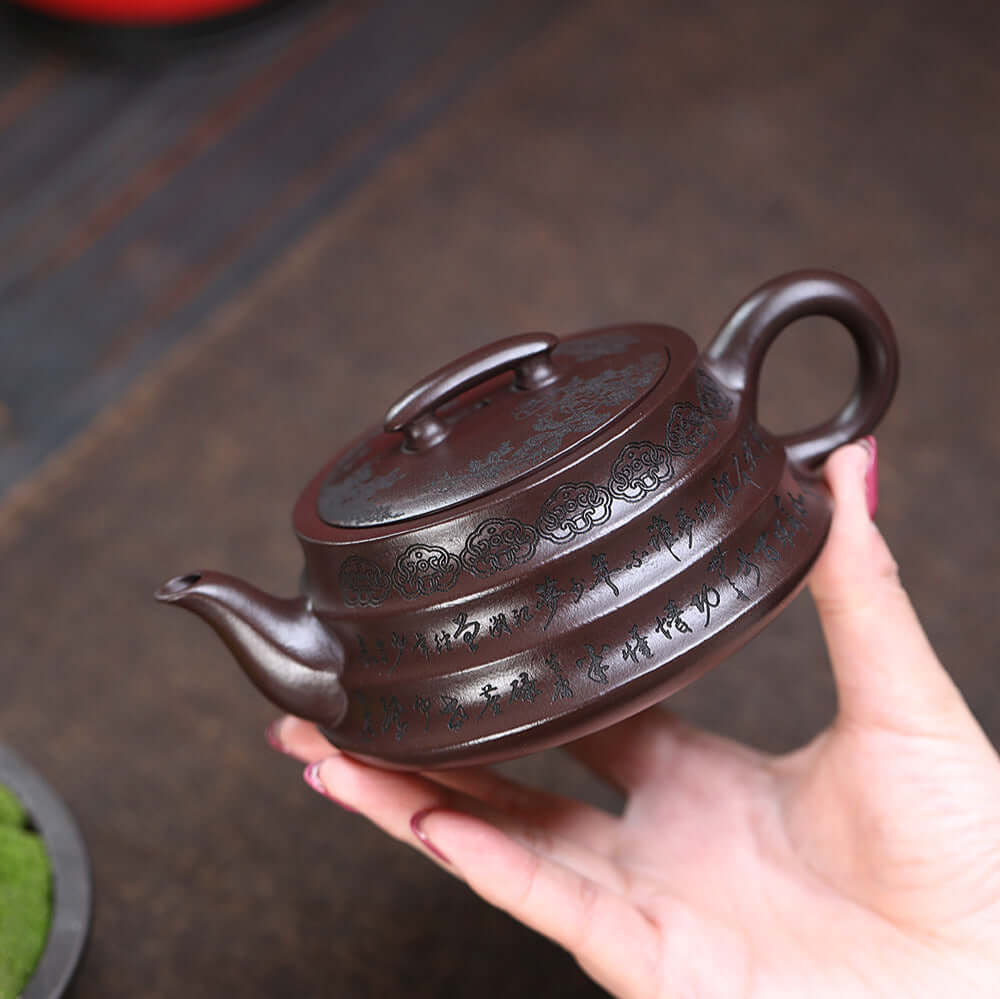 Handmade Yixing purple sand teapot with intricate design, perfect for Kung Fu tea set enthusiasts.