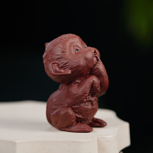 Handmade Yixing purple sand tea pet sculpture of a happy monkey, perfect for tea table ornaments.