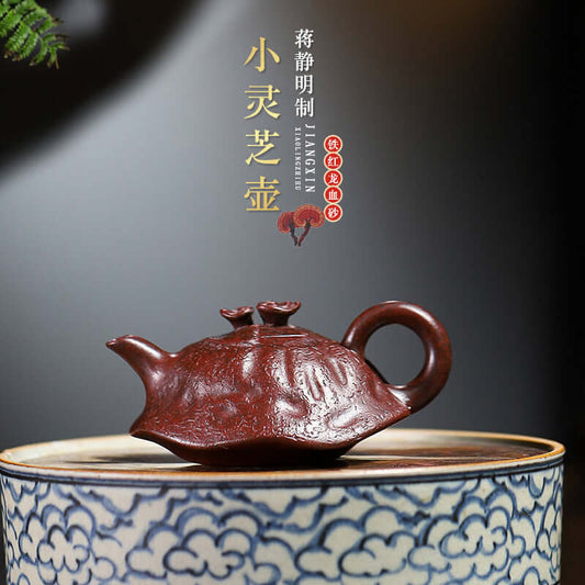 Handmade Yixing purple sand teapot, crafted from iron red dragon blood sand, featuring elegant design and traditional artistry.