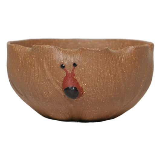 Handmade Yixing purple sand tea cup featuring a unique snail design, showcasing artisanal craftsmanship.