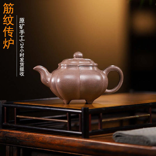 Handmade Yixing purple sand teapot with a ribbed design, crafted by skilled artisans for superior tea enjoyment.