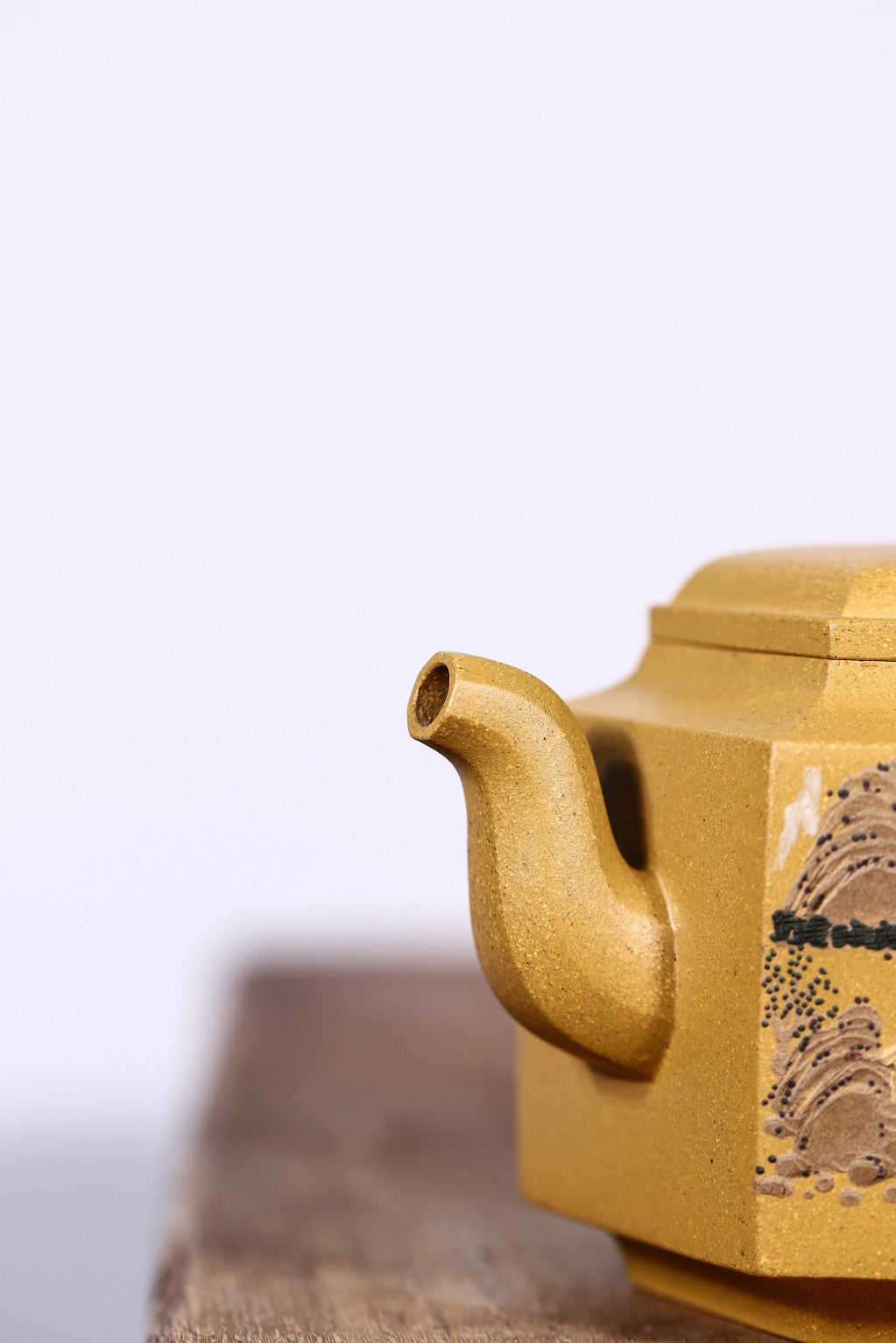 Handmade Yixing purple sand teapot, featuring unique design and golden color, ideal for tea lovers.