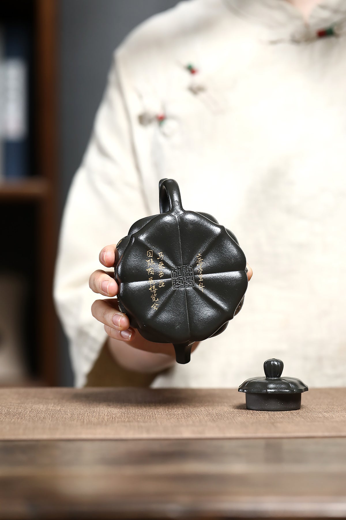 Handmade Yixing purple sand teapot with pumpkin shape, featuring intricate details and craftsmanship.