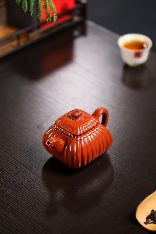 Handmade Yixing purple sand teapot, original design, showcasing elegant curves and details on wooden table.