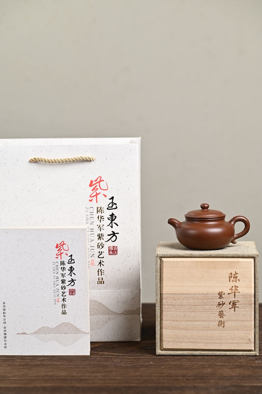 Handmade Yixing purple sand teapot in gift box with certificate, showcasing artisanal craftsmanship.