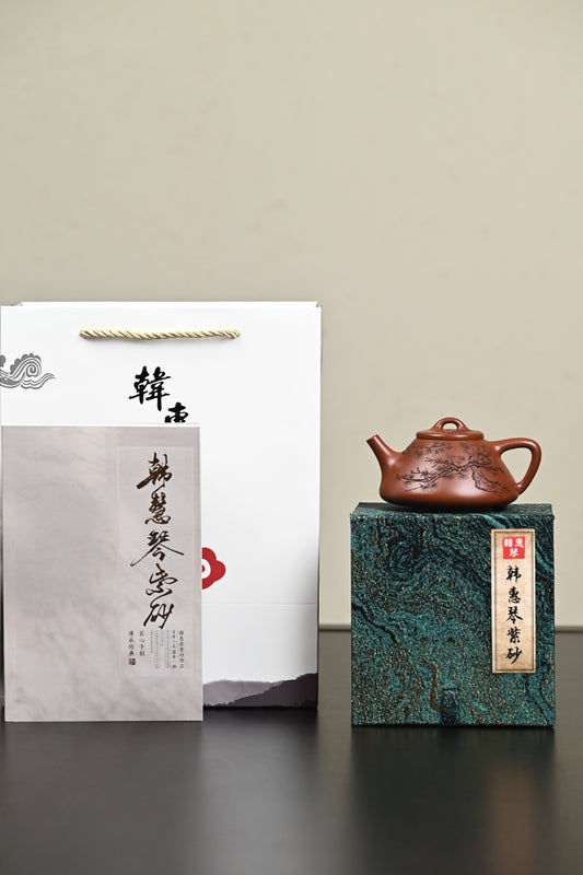 Handmade Yixing purple sand teapot displayed with a gift box and certificate of authenticity.