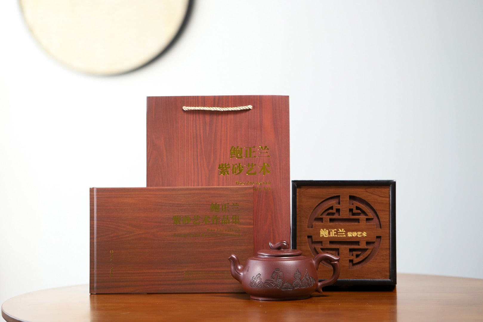 Handmade Yixing purple sand teapot with elegant wooden packaging on display.