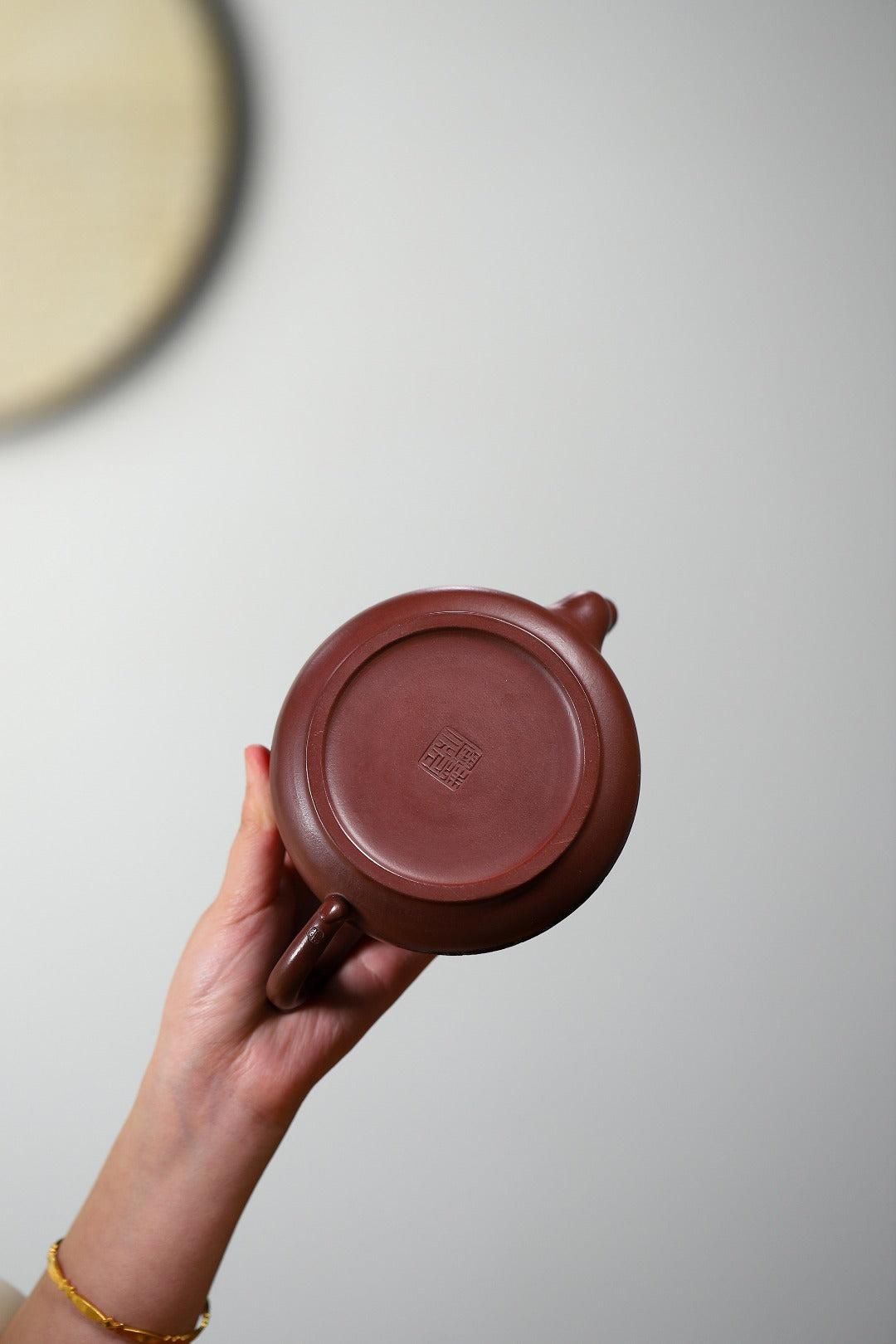 Bottom view of a handmade Yixing purple sand teapot with impressive craftsmanship detail.