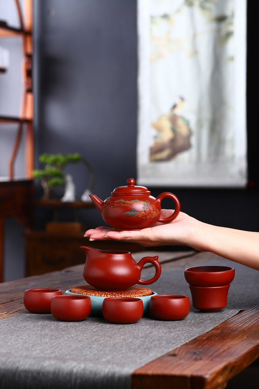 Handmade Yixing purple sand teapot set, showcasing craftsmanship with tea cups on a wooden table.