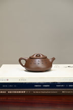 景舟石瓢·全手工 容量250cc/家藏紫泥 壶身呈梯形，曲线柔和流畅，桥钮搭接在平盖之上