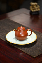 茄瓜·全手工/容量180cc/朱泥包金 形式娇巧，若一茄瓜熟落，湾流微微翘起，提把上扬，圆润饱满