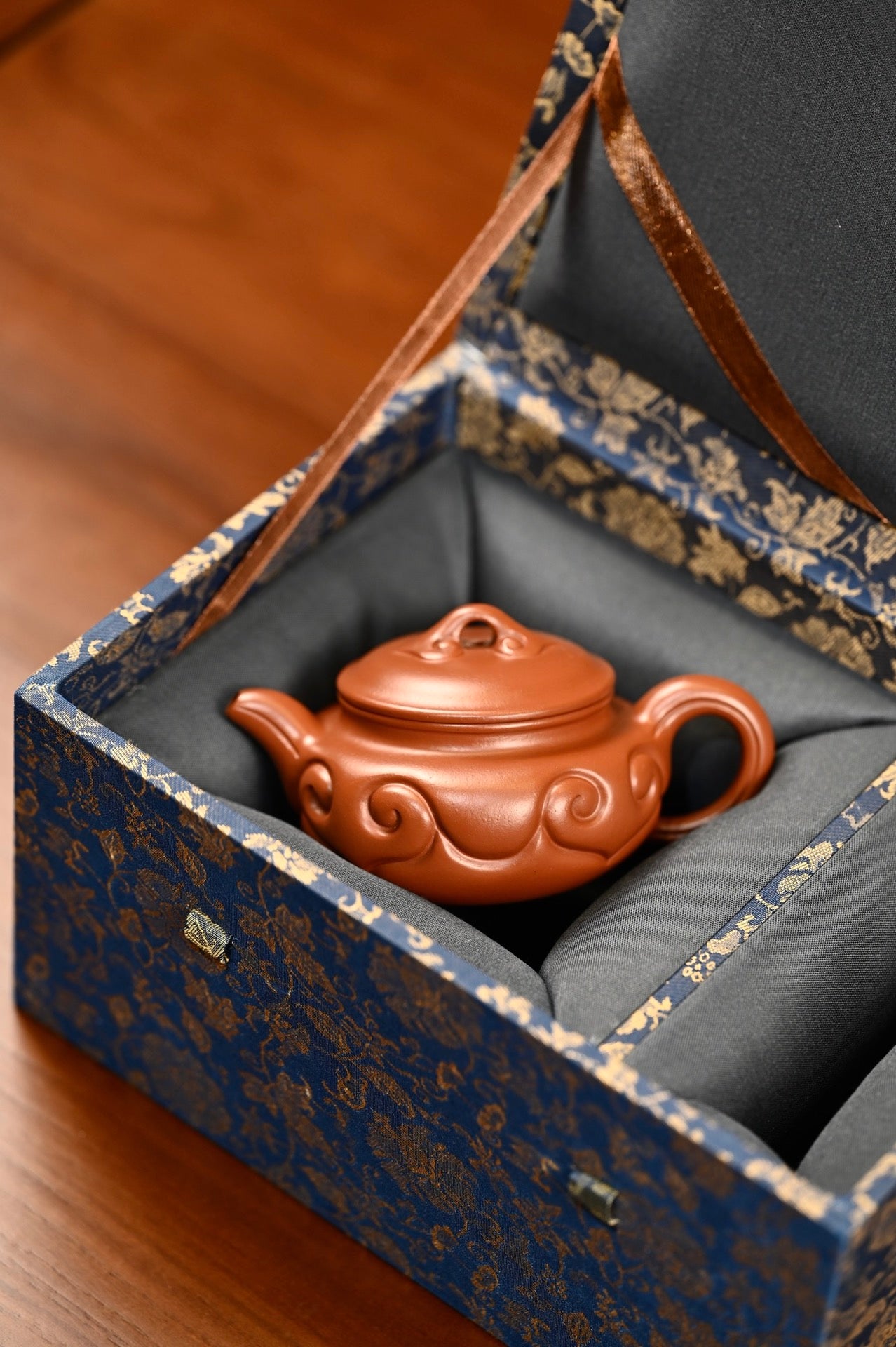 仿古如意·全手工/容量120cc/极品朱泥 壶身由如意云纹组成，柔美雅致，钮为如意桥梁式，与云纹呼应