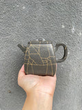 High stone teapot by Yang Junbao, handmade zisha teapot with elegant design, showcasing unique clay texture.