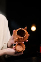 Ming Dynasty colorful stone teapot held, showcasing its craftsmanship and design, handmade zisha teapot.