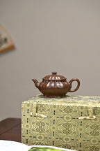 Handcrafted purple clay teapot 200cc displayed on a decorative box showcasing its elegant design.